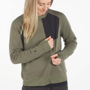 a woman showing off the zipper chest pocket in a Cloudripper Crew Neck Pullover in Surplus Green