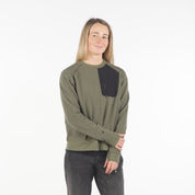 a woman wearing a Cloudripper Crew Neck Pullover in Surplus Green with dark jeans