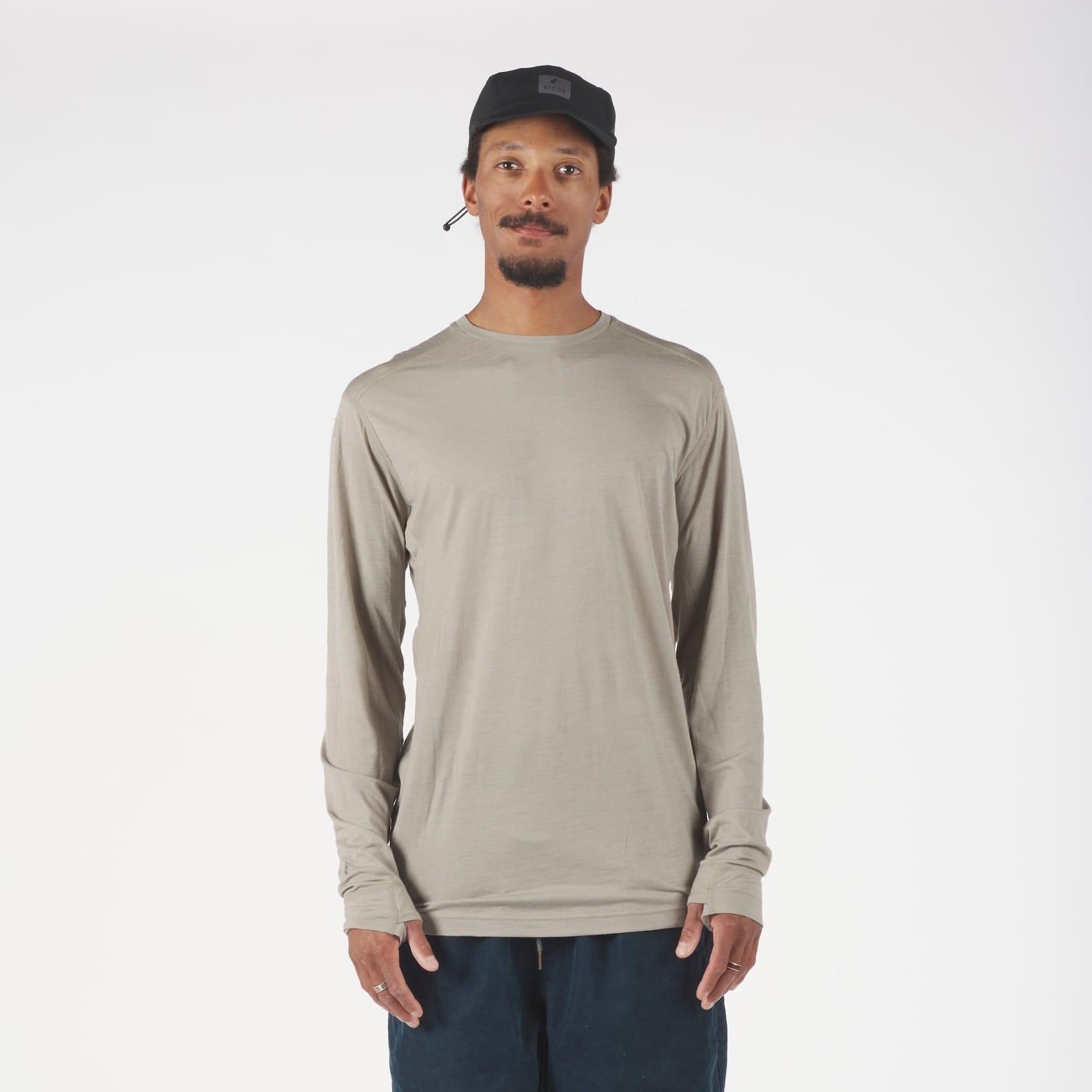 a man wearing a Rock Ridge Pursuit Long Sleeve Ultralight Merino Shirt