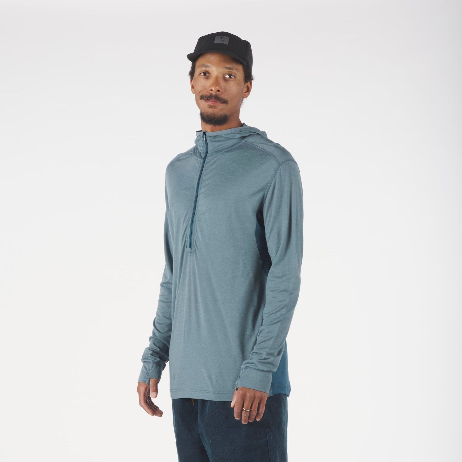 a man wearing a Pursuit Air Hoodie with the zipper up