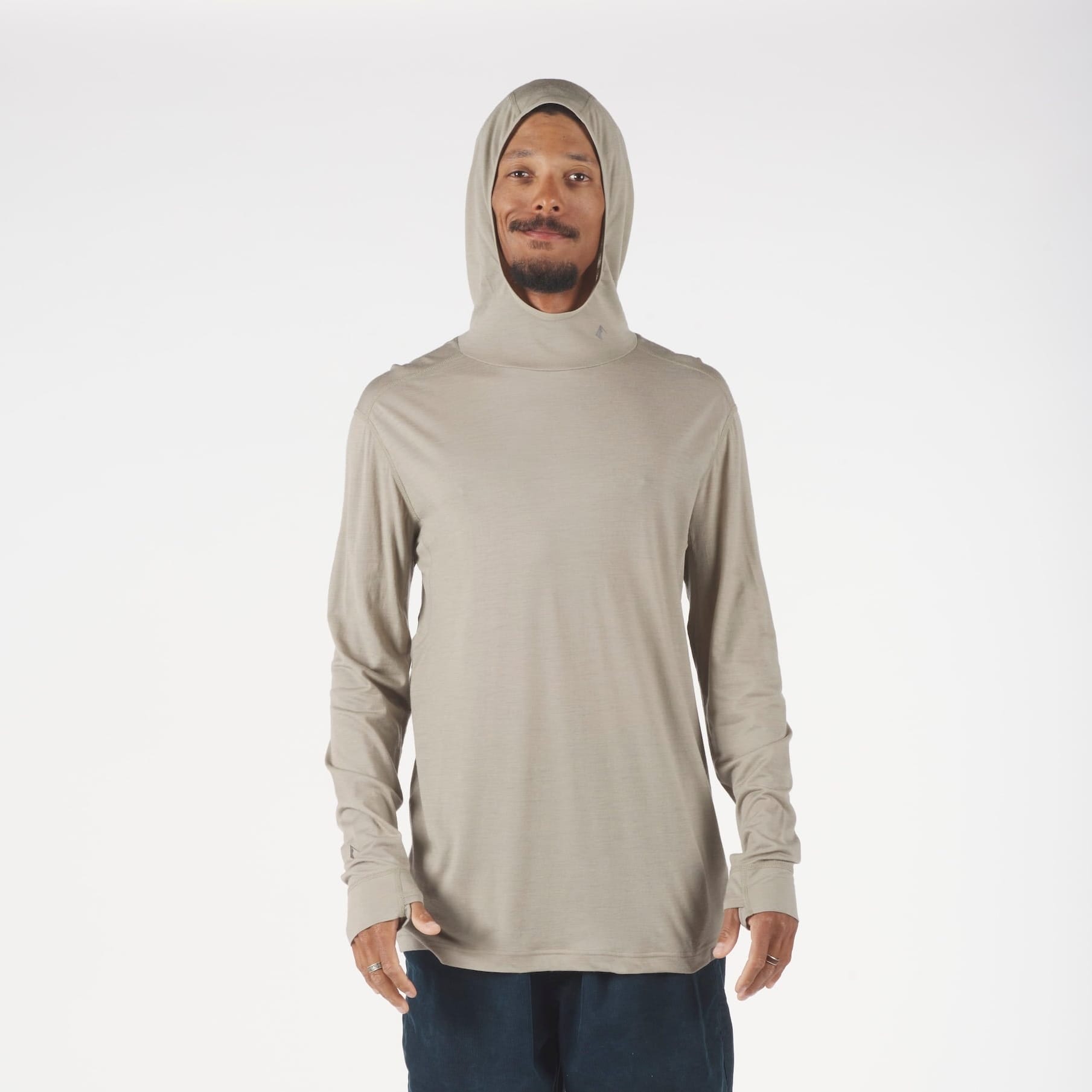 a man wearing a Ridge Merino Wool Pursuit Ultralight Hoodie in Rock Ridge