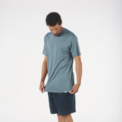 a man wearing a blue Pursuit Air Merino Mesh T-shirt