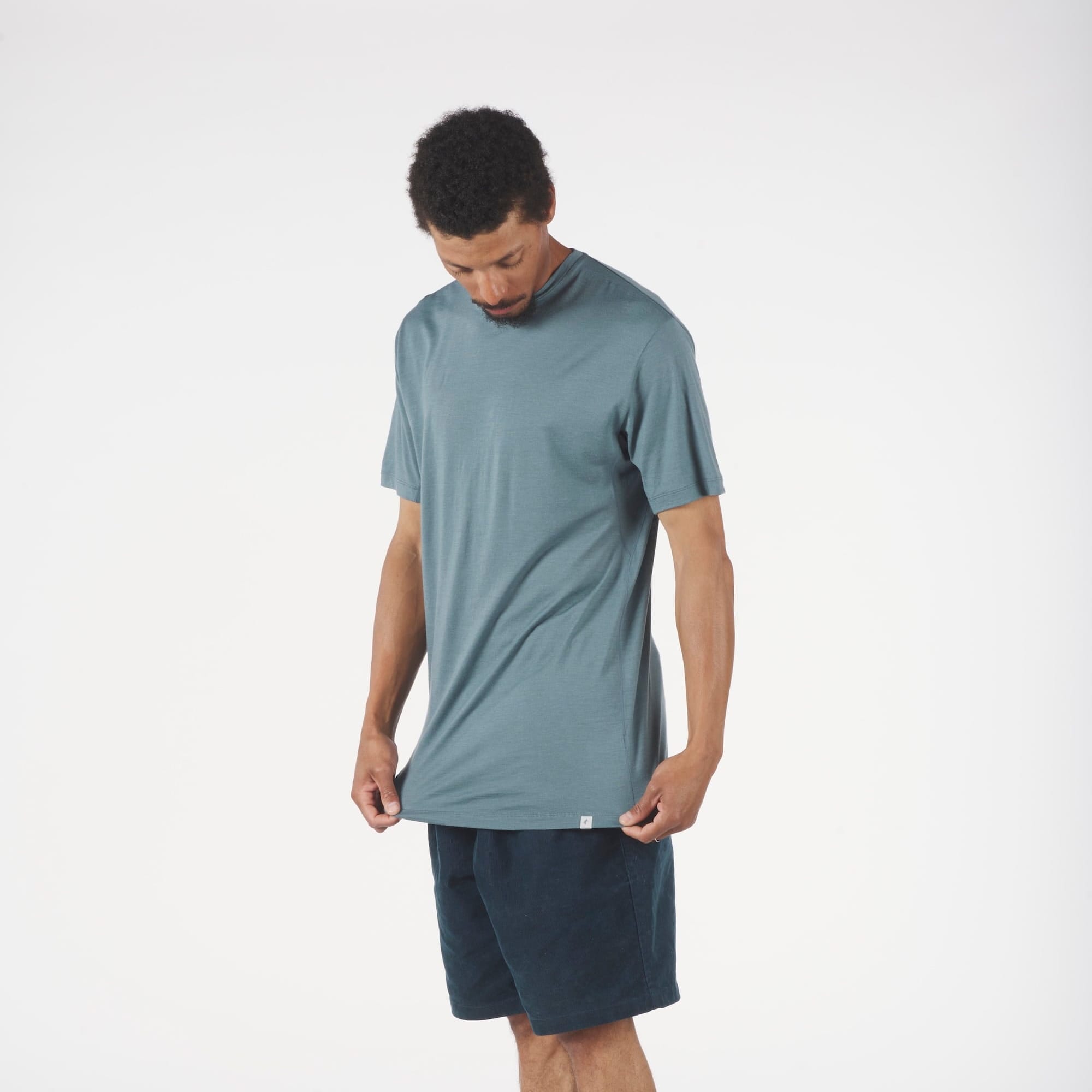 a man wearing a blue Pursuit Air Merino Mesh T-shirt