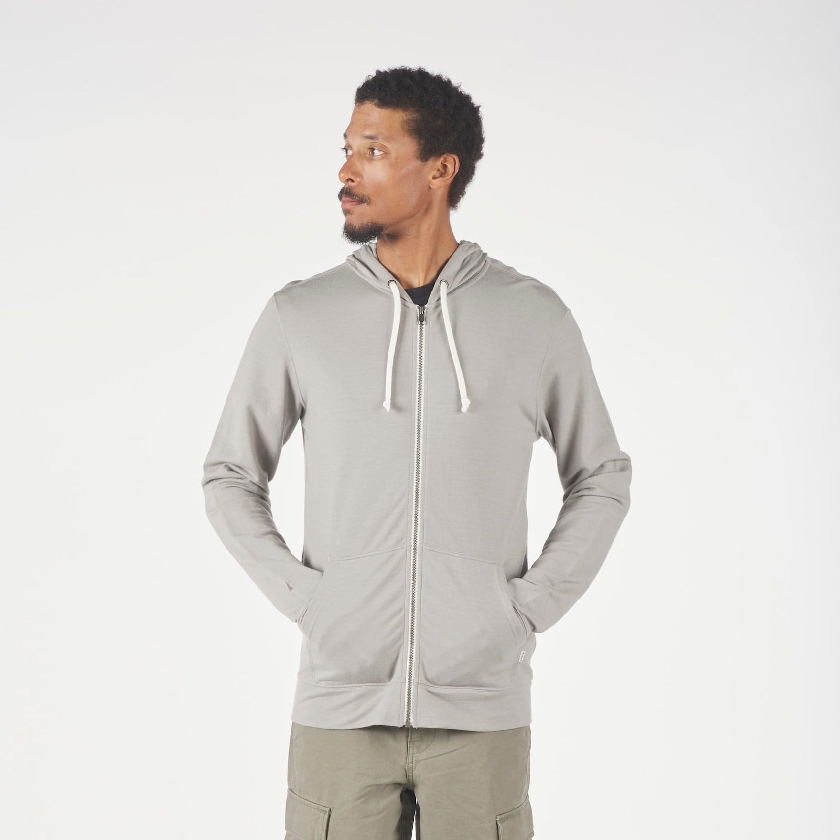 a man wearing a Ridge Merino Traveler Hoodie in Rock Ridge