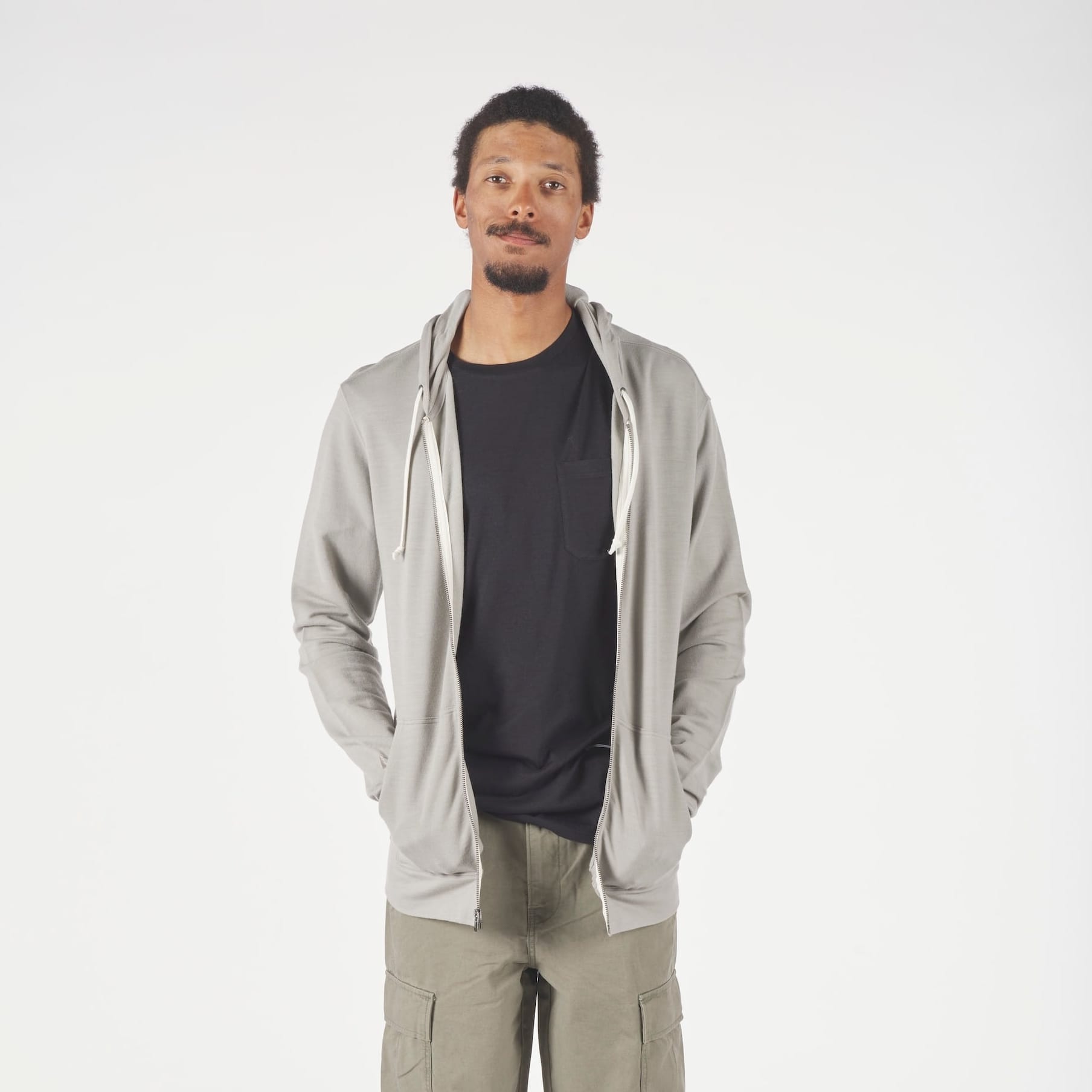 a man wearing a Men's Traveler Hoodie in Rock Ridge with a black Journey Pocket Tee underneath