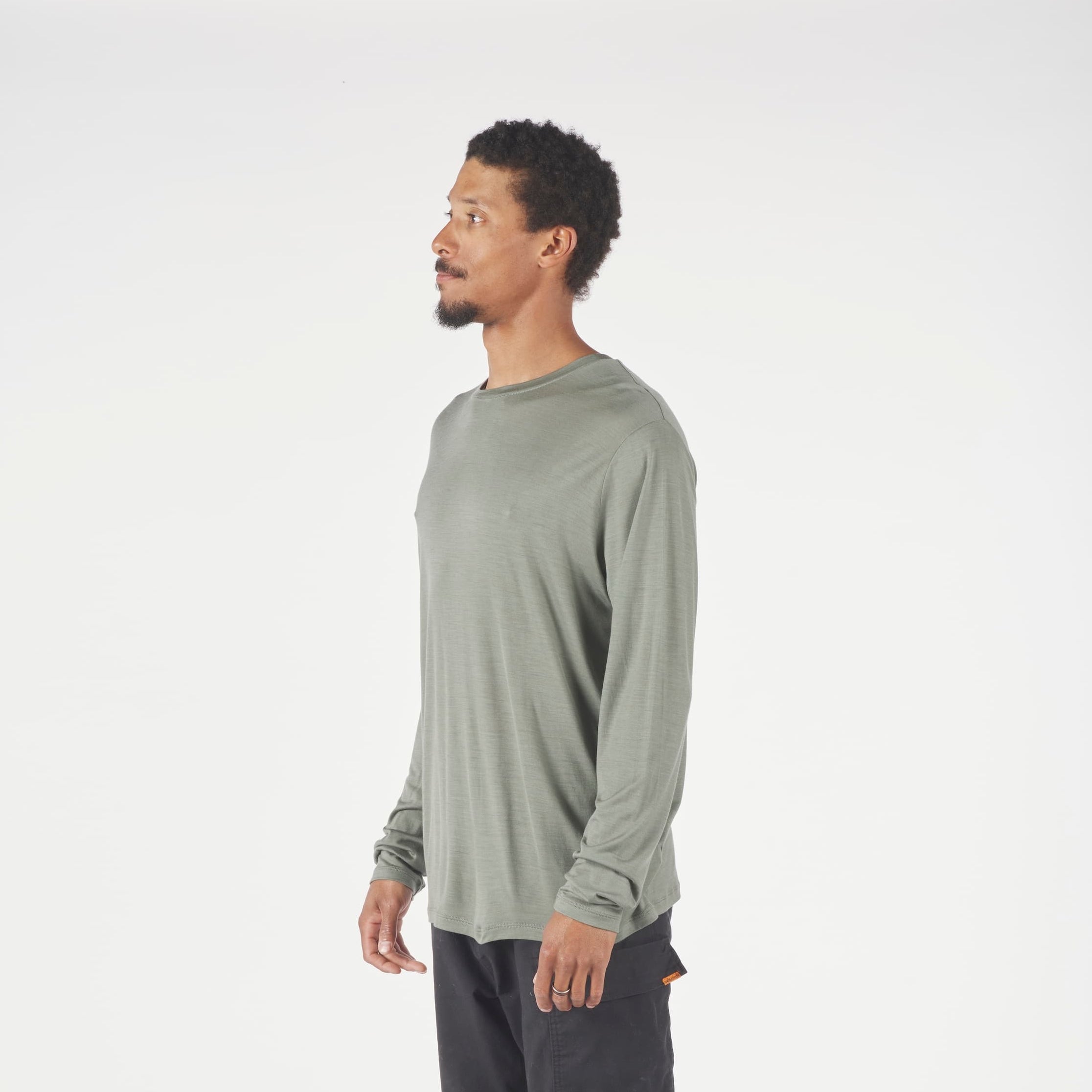 A man wearing a long sleeve Canopy Shirt in Agave Green