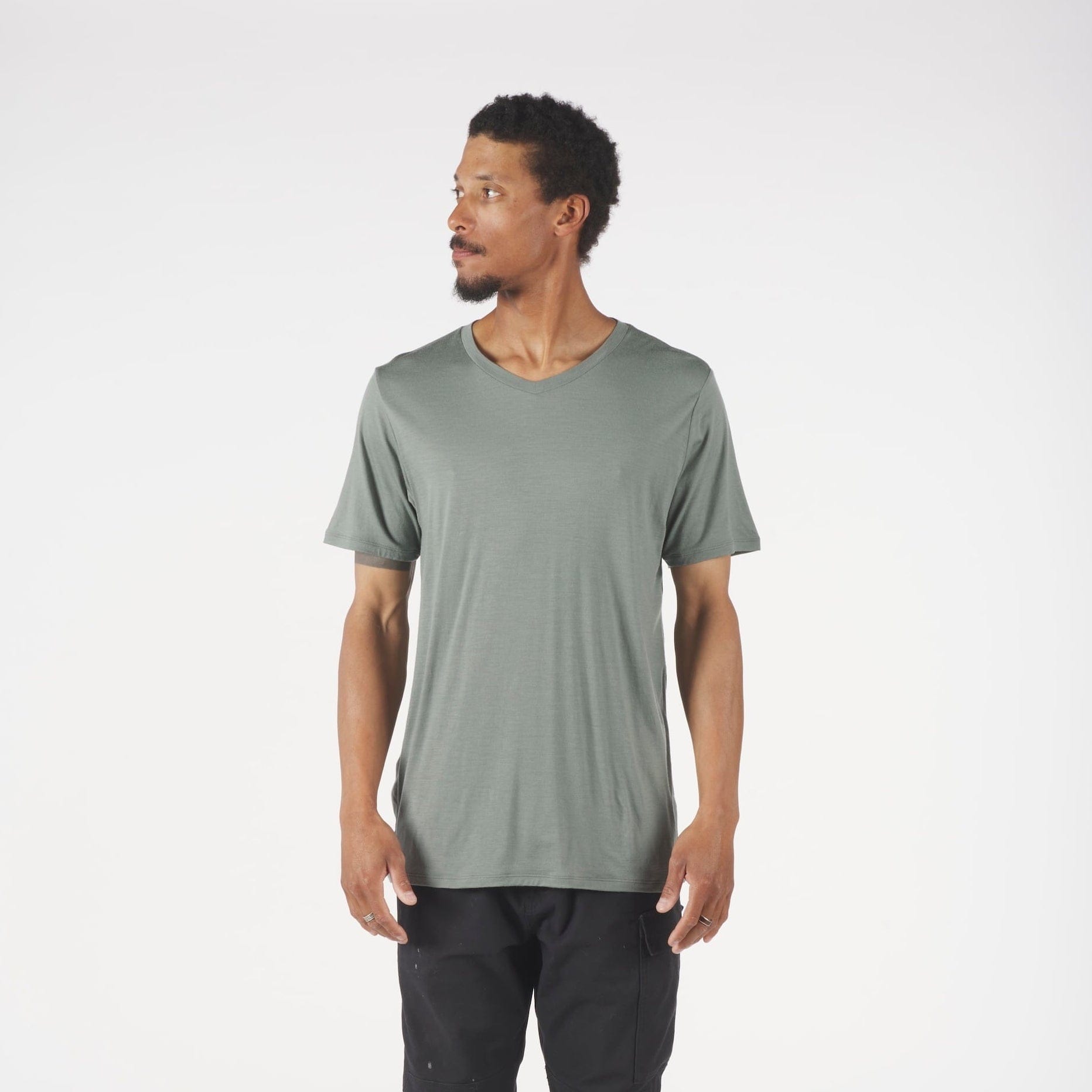 a man wearing a green Journey V-Neck Merino Wool T-shirt