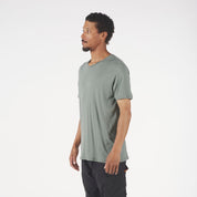 a man wearing a green Journey V-Neck Merino Wool T-shirt
