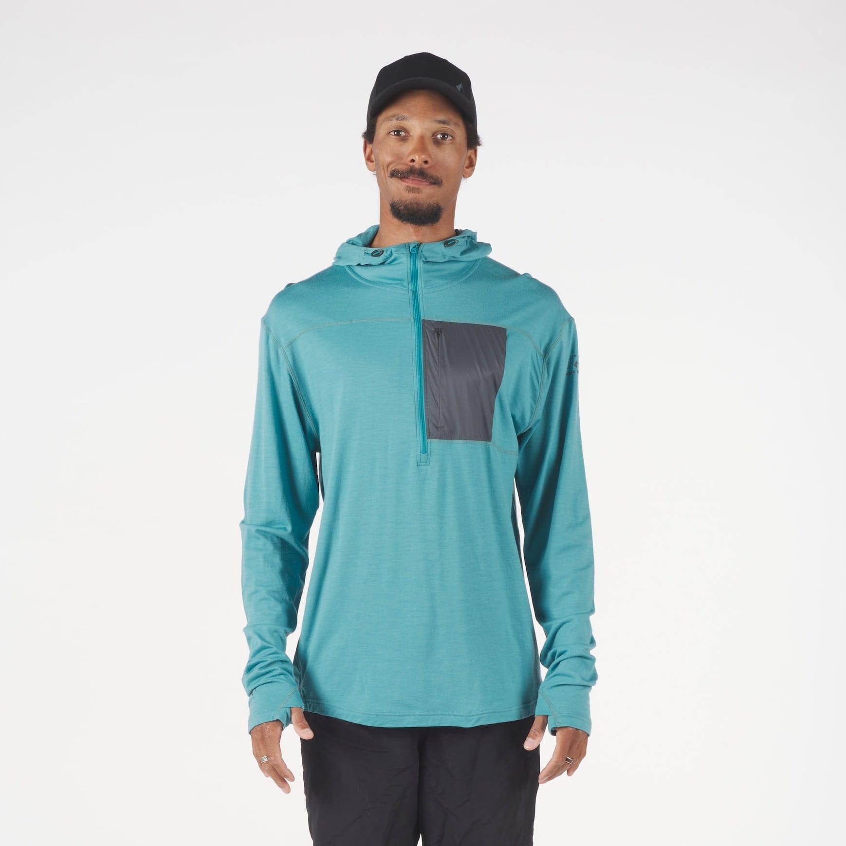 a man wearing a Solstice Pro Merino Wool Sun Hoodie in teal
