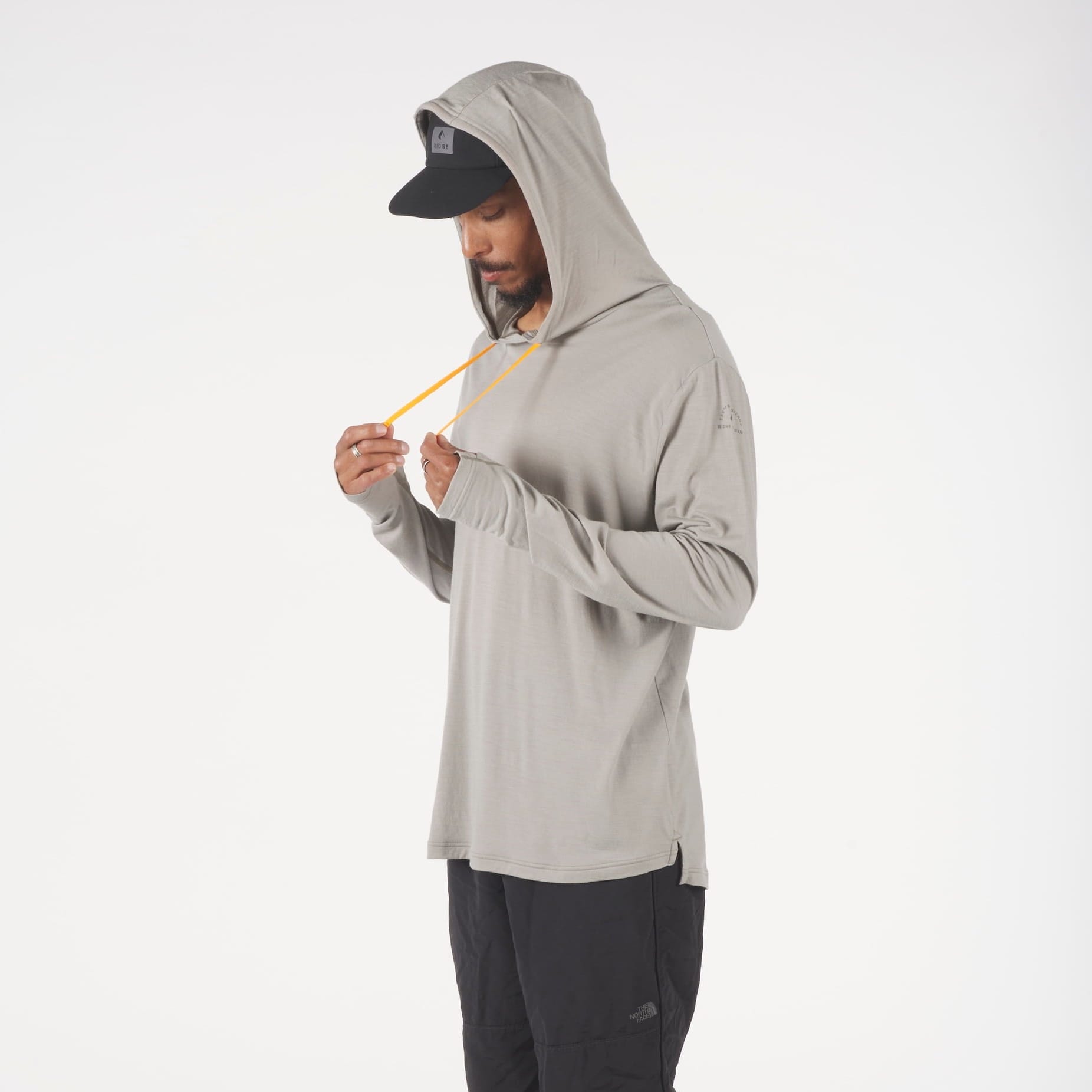 a man wearing a tan Solstice Merino Wool Sun Hoodie