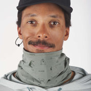 a man wearing a Sierra Neck Tube with the Backpacker Print and a Ridge Run Hat