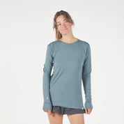 a woman wearing a Pursuit Ultralight Merino Long Sleeve Shirt