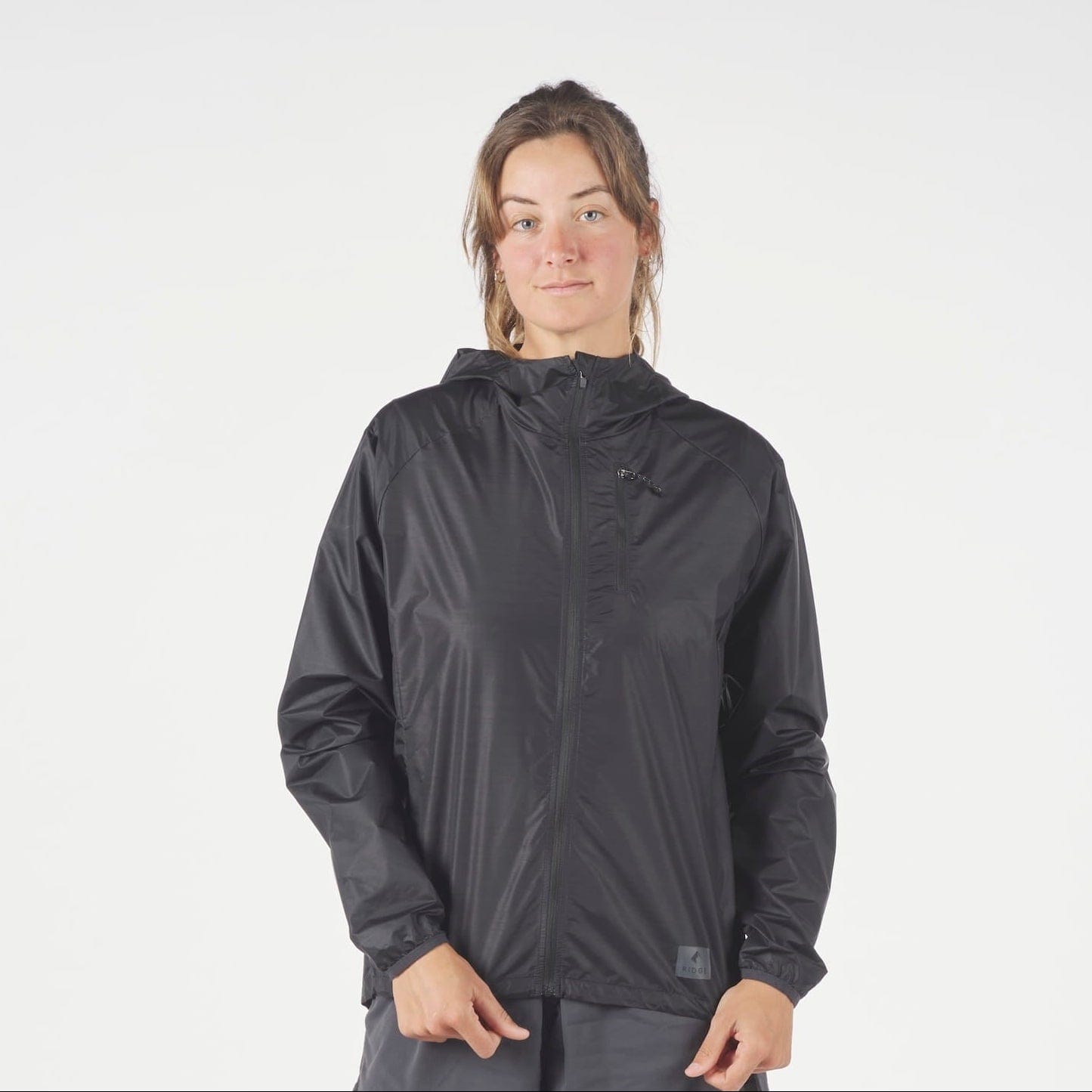 a woman wearing a black Windshifter Windbreaker