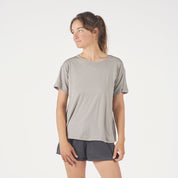 a woman wearing a Journey Merino Wool Relaxed Fit T-shirt in Rock Ridge with running shorts