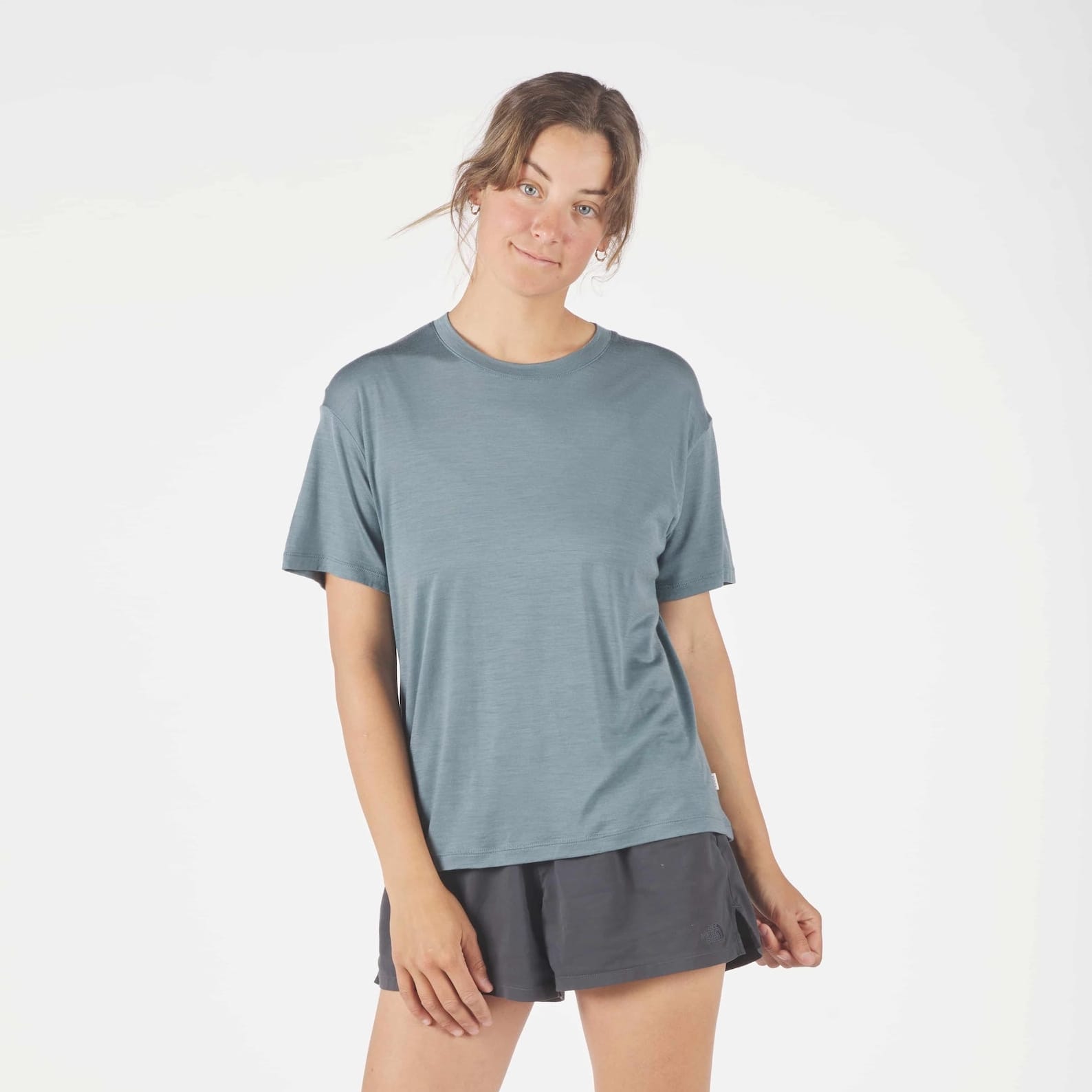 a woman wearing an Overcast Blue Canopy Merino Tencel T-Shirt