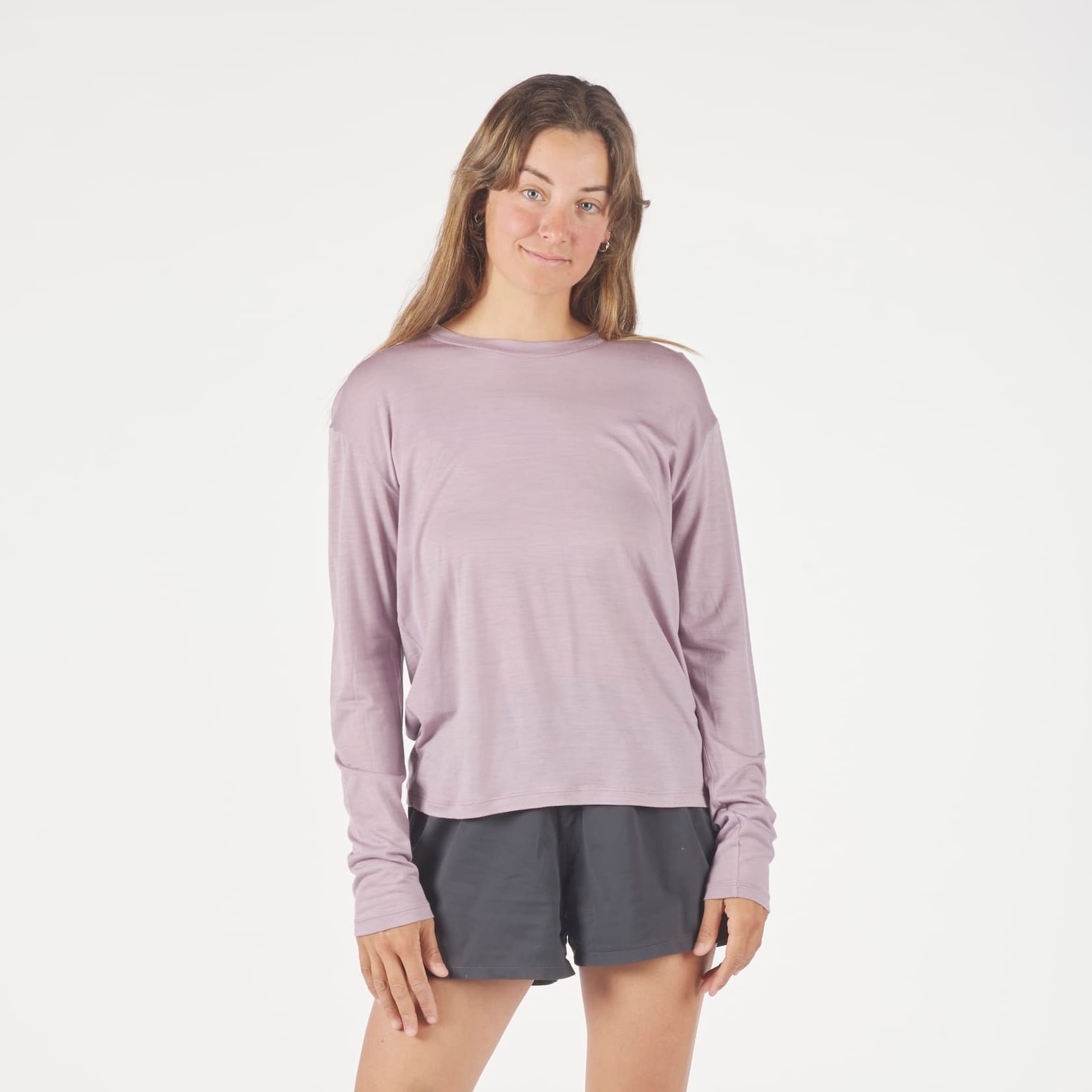 a woman wearing a Dusty Lilac Canopy Long Sleeve Merino Tencel Shirt