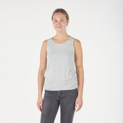 a woman wearing an Ice Flow Journey Merino Wool Tank Top