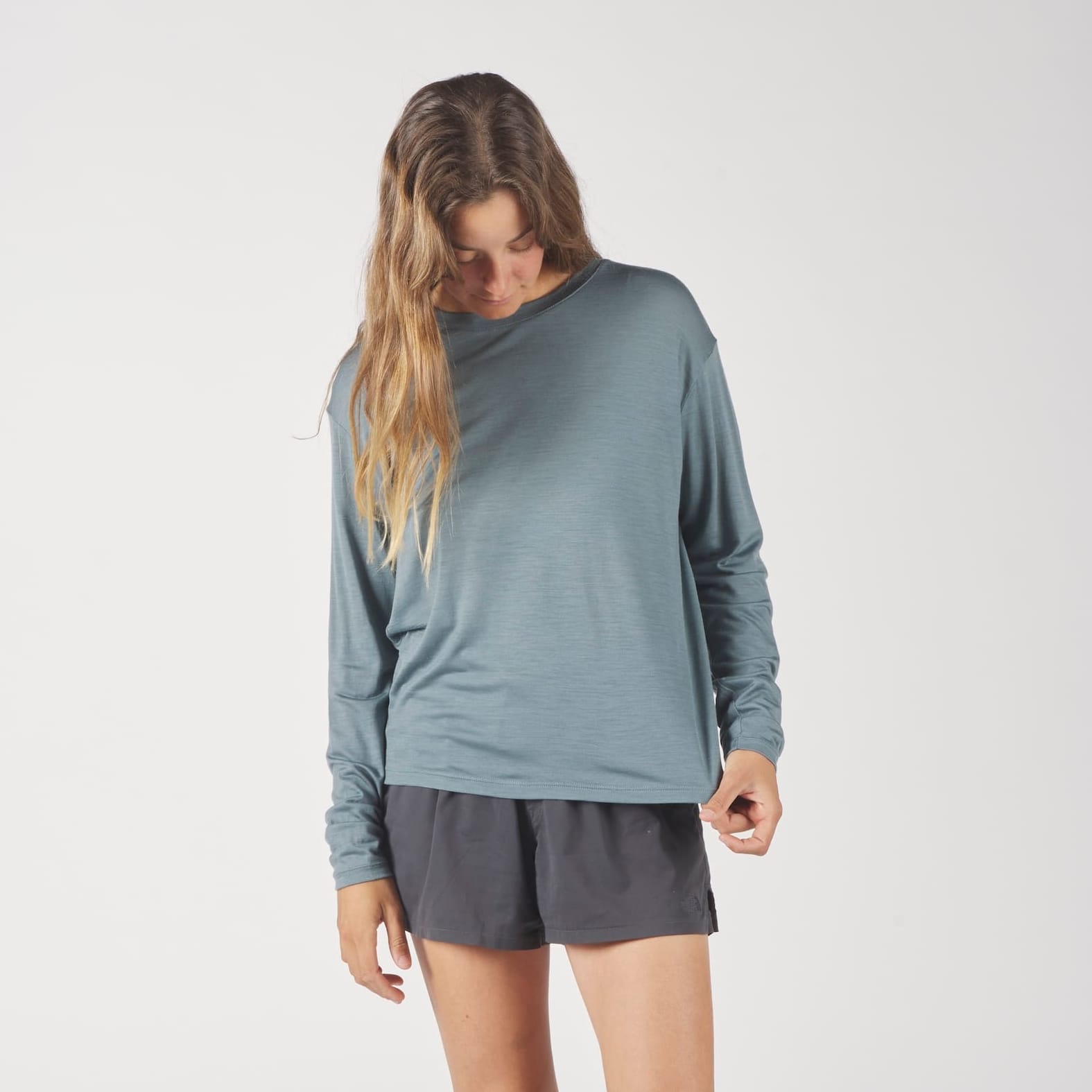 a woman wearing a blue Canopy Long Sleeve Merino Tencel Shirt