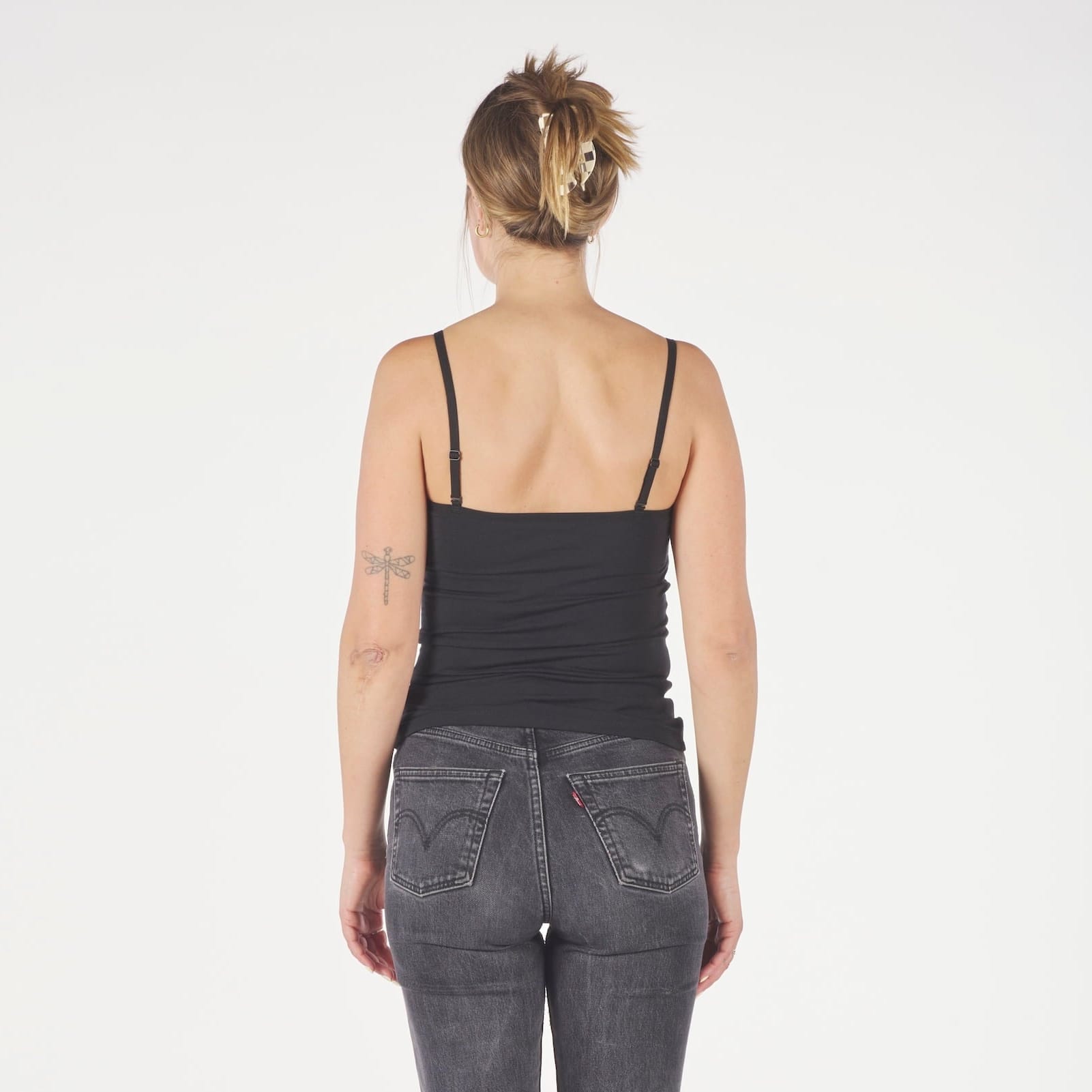 a woman wearing a black Ridge Merino Wool Cami Tank