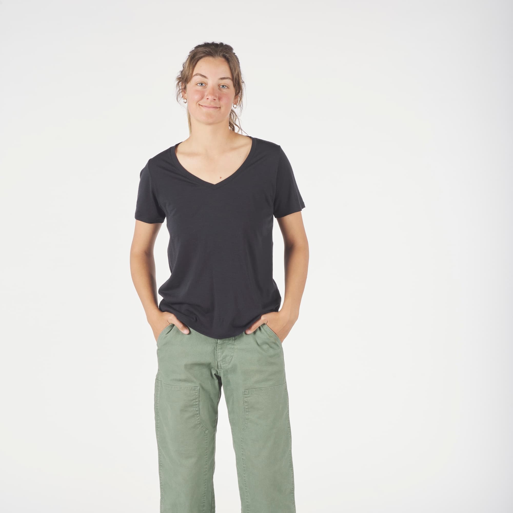 a woman wearing a Journey Merino Wool V-Neck T-Shirt in black with green cargo pants