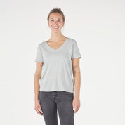 a woman wearing a Journey Merino Wool V-Neck T-Shirt in Ice Flow with black jeans