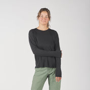 a woman wearing a black Canopy Merino Tencel Long Sleeve Shirt