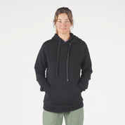 a woman wearing a Ridge Merino Onsen Hoodie in black with green cargo pants