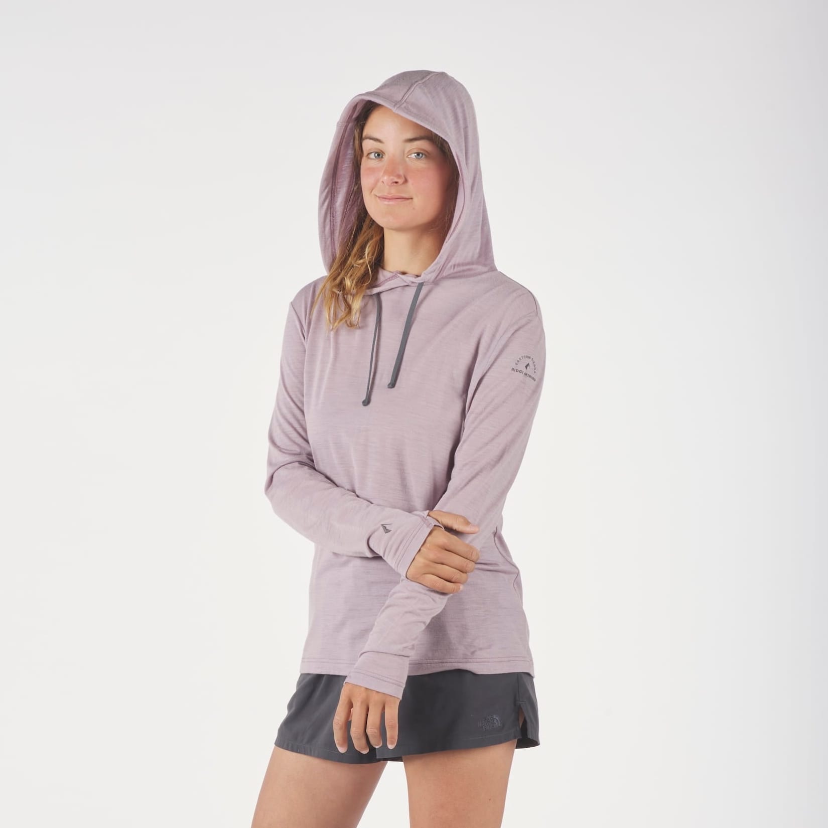 a woman wearing a Solstice Merino Wool Sun Hoodie in Dusty Lilac