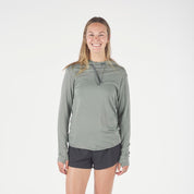a runner wearing a Solstice Merino Sun Hoodie in Agave Green