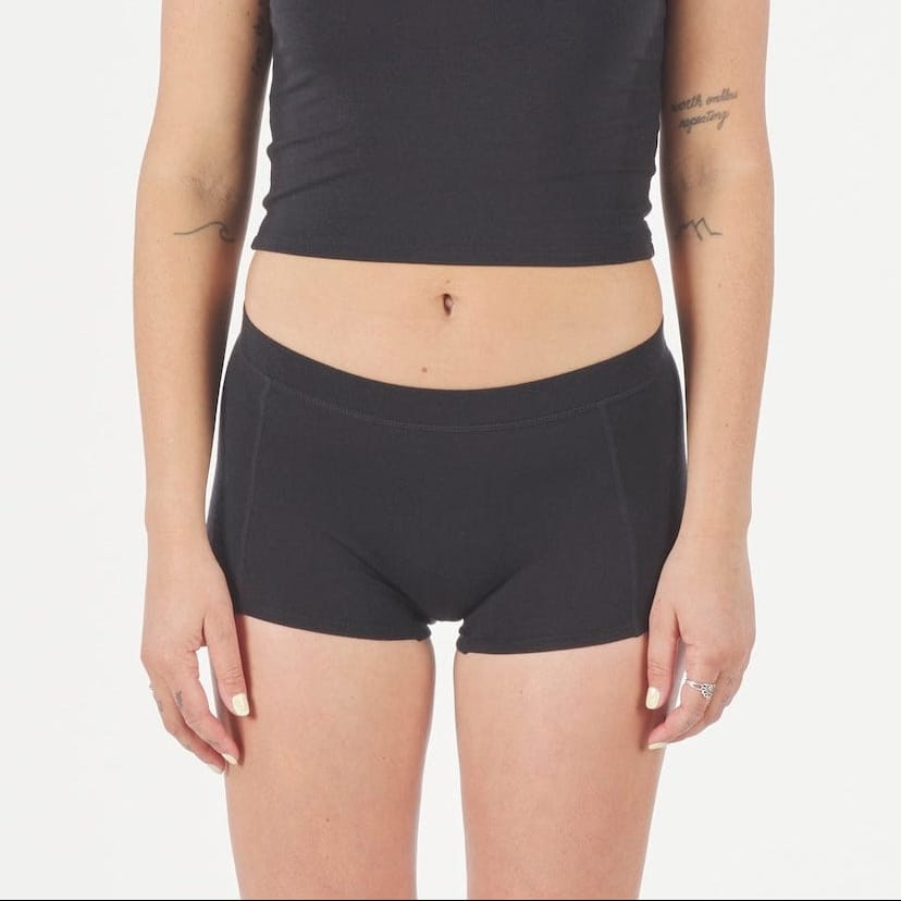 a woman wearing black Ridge Merino Boy Short Underwear with a black Ridge Merino Bralette