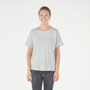 a woman wearing a Journey Merino Wool Relaxed Fit T-shirt in Ice Flow with black jeans