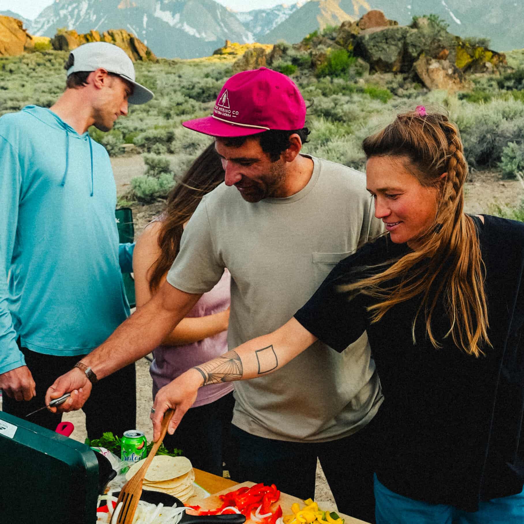 a man wearing a Journey Merino Wool Pocket Tee grilling with friends