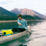 a man canoeing in a Ridge Merino Solstice Sun Hoodie in tie-dye - photo by Carson Cox