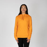 a woman wearing an orange Solstice Sun Hoodie