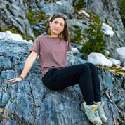 a woman sitting on a rock wearing a Ridge Merino Wool Oversized T-Shirt