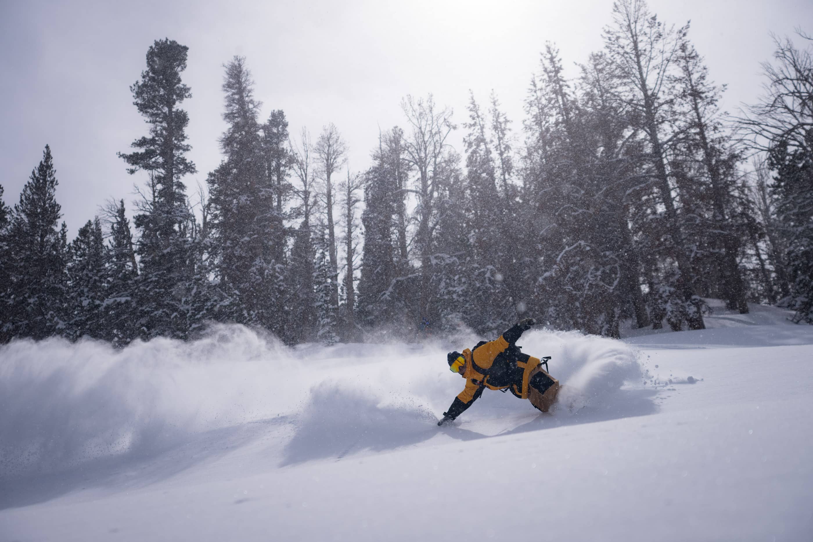 Tim Humphreys snowboards in the backcountry wearing Ridge Merino base layers