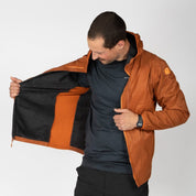 a man wearing an orange Alpha Wool Insulated Jacket with a Merino base layer underneath
