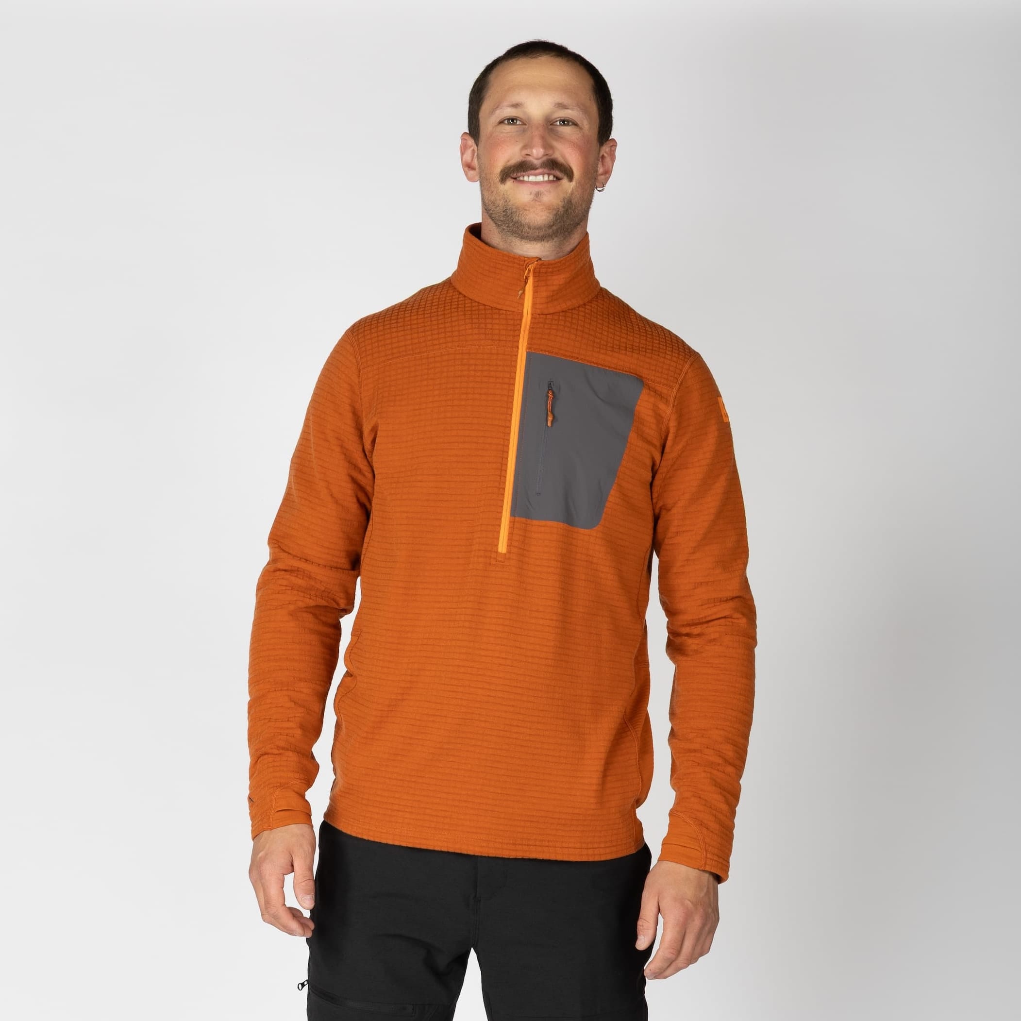 a man wearing a Cinnamon Half Zip Cloudripper Merino Grid Fleece Pullover
