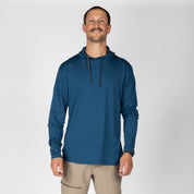 a man wearing a blue Solstice Sun Hoodie with hiking pants