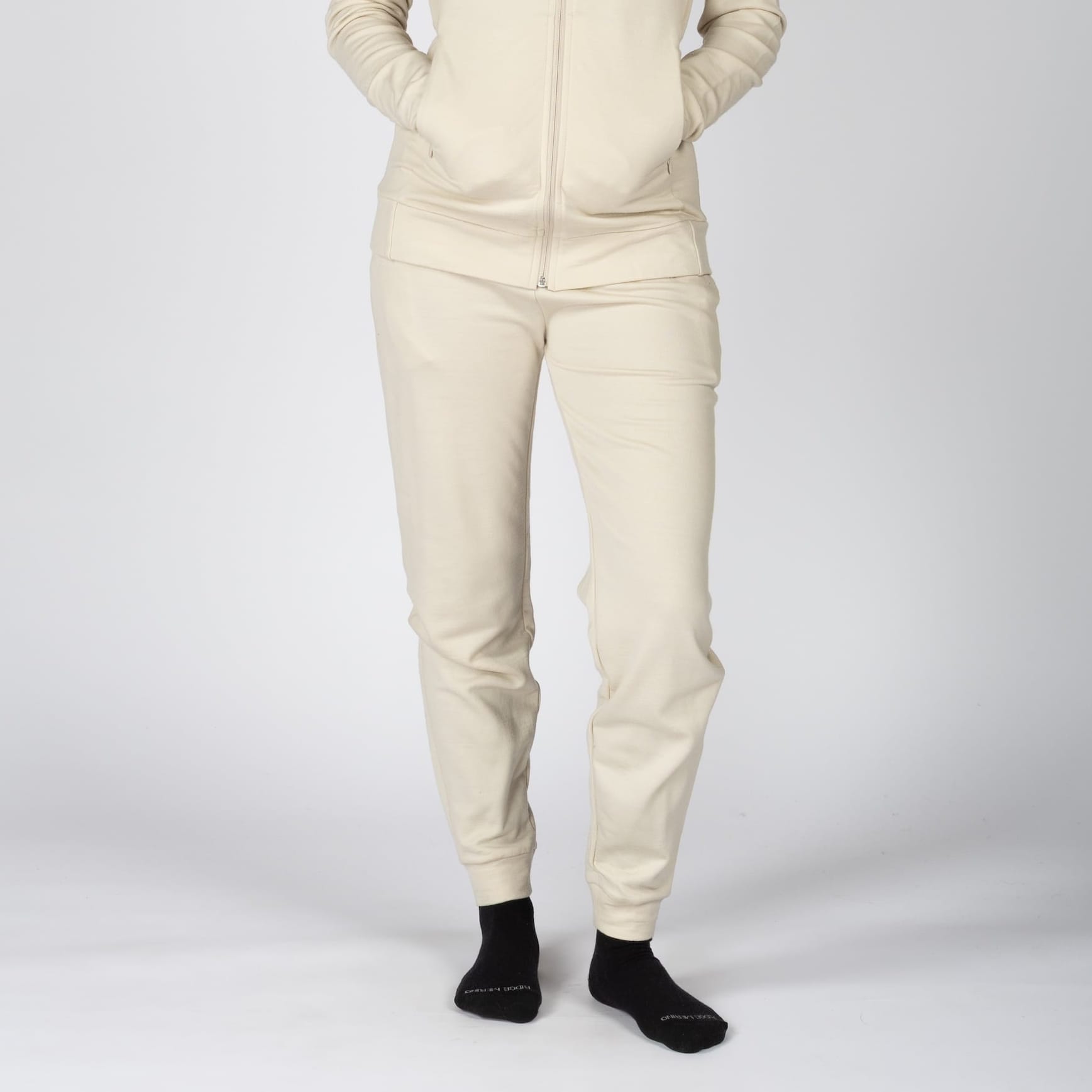 a woman wearing Sand 100% Merino wool Hyde Joggers with a Sand Merino Hoodie