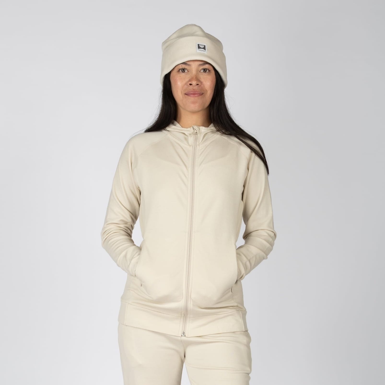 woman wearing a 100% Merino Wool Hyde Hoodie in Sand with matching joggers