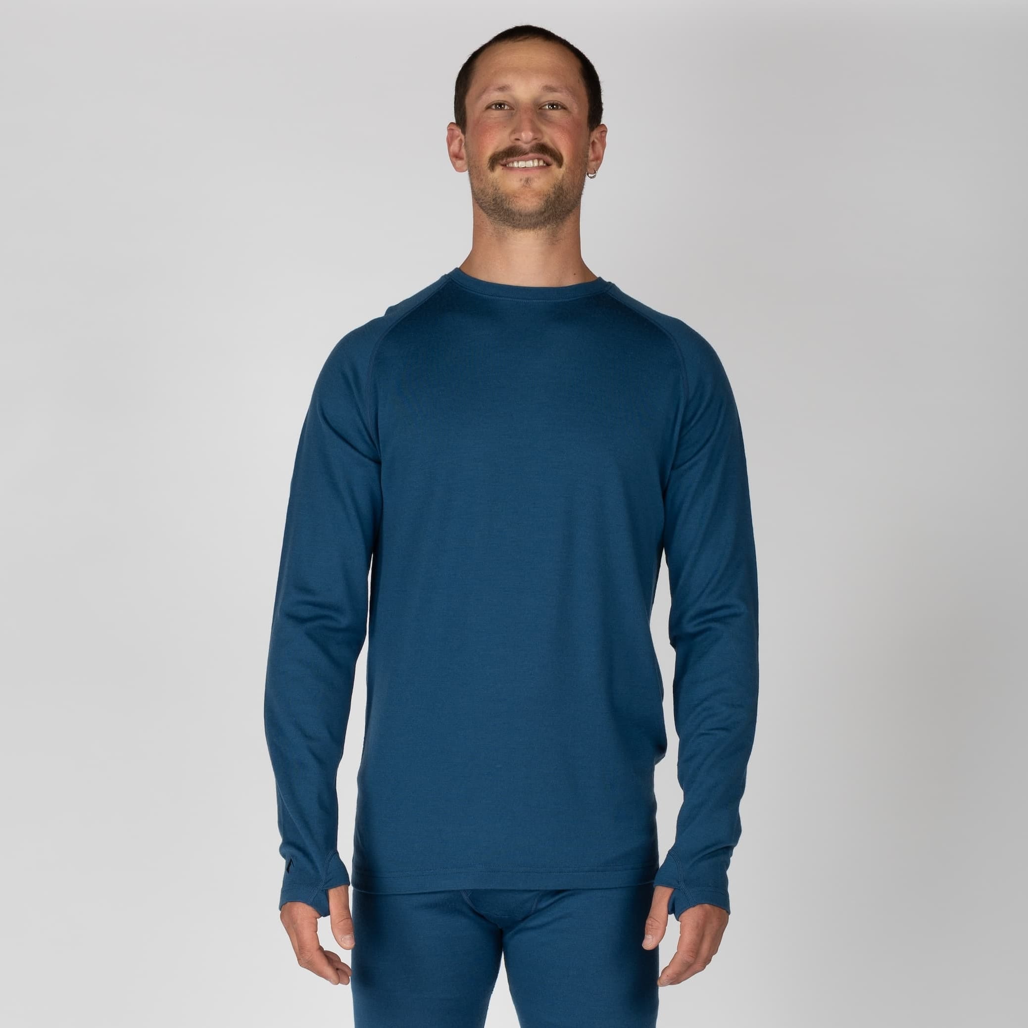 a man wearing a Sailor Blue Aspect Base Layer Shirt