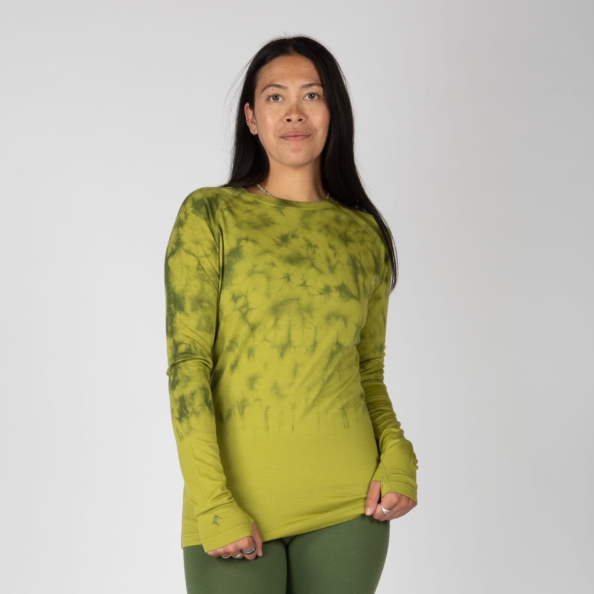 a woman wearing an Aspect Shirt in Golden Lime Tie-Dye with Fern green Aspect Bottoms