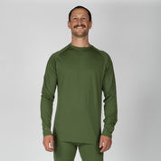 a man wearing an Aspect Base Layer Top in Fern