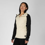 a woman wearing a Convict Canyon Hoodie in Sand/Black with black hiking pants