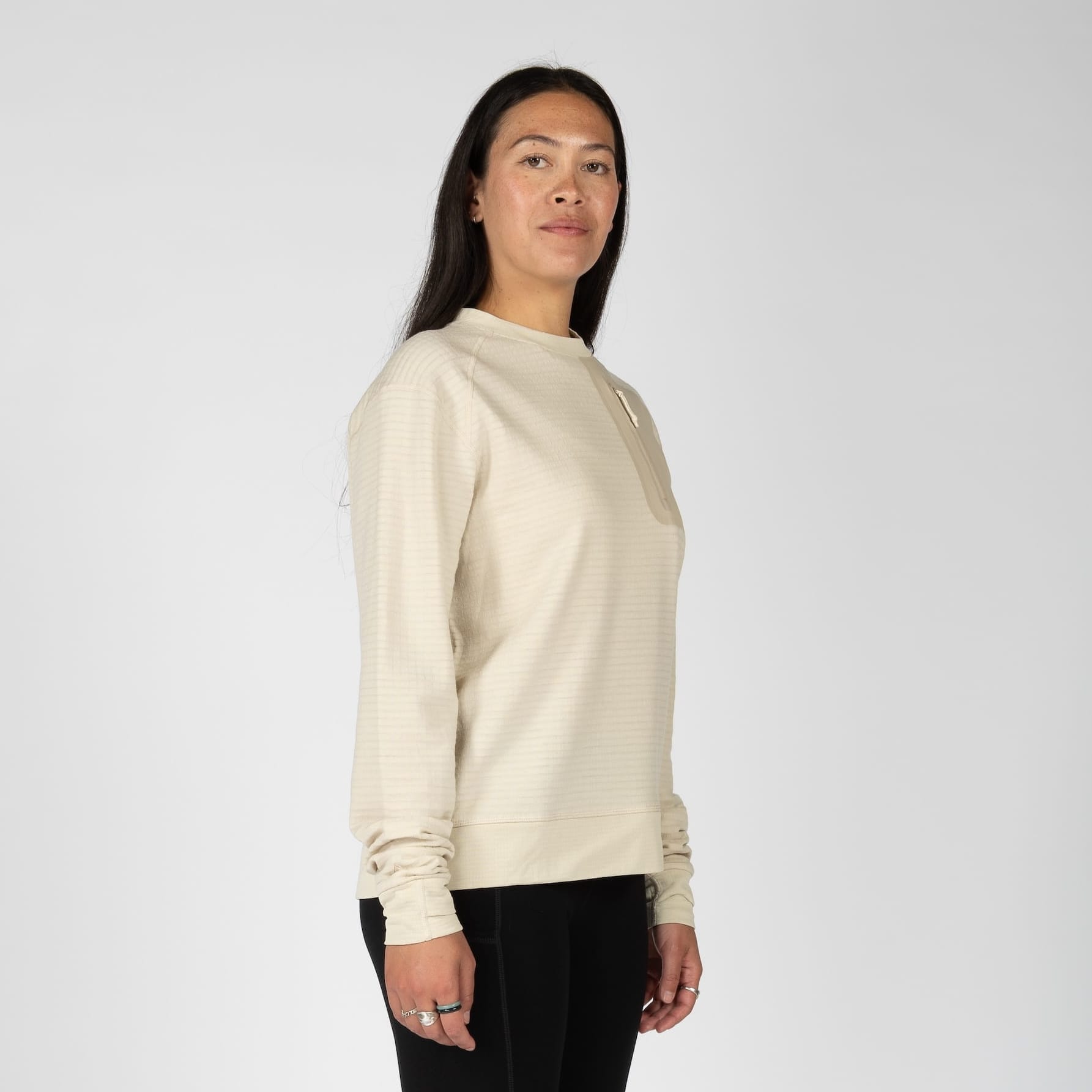 a woman wearing a Cloudripper Crew Pullover in Sand
