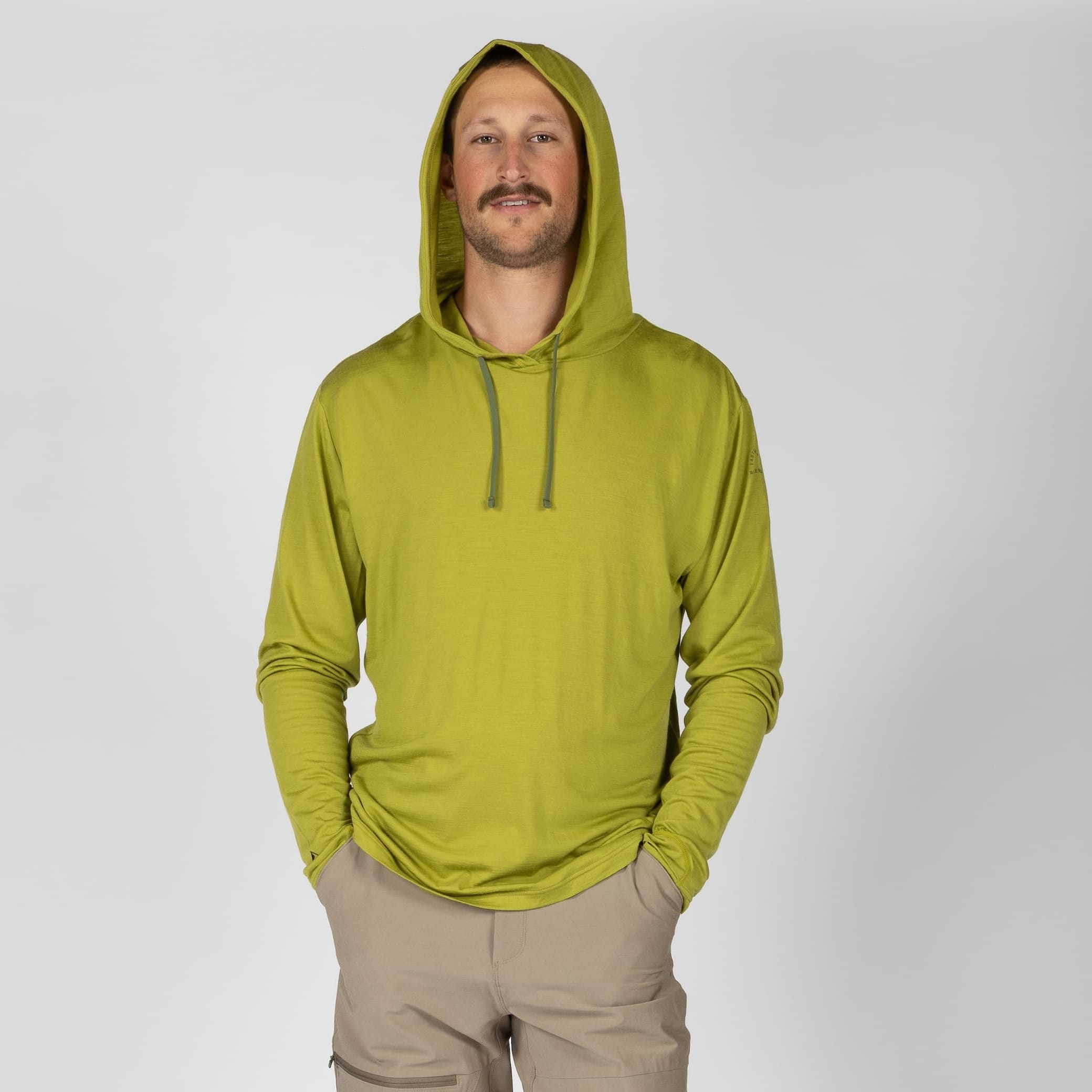 a man wearing a Golden Lime Solstice Sun Hoodie and hiking pants