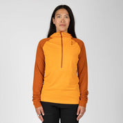 a woman wearing a Convict Canyon Hoodie in orange with black hiking pants