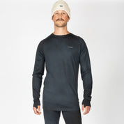 a man wearing an Aspect Base Layer Top in Black Garment Dye with a Ridge logo on the chest