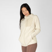 a woman wearing a Cloudripper Full Zip Grid Fleece Jacket in Sand
